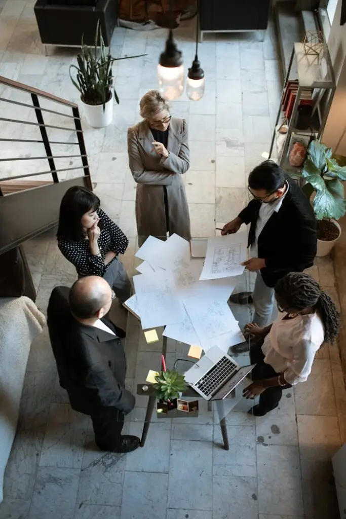 pexels-photo-5922204 A team of professionals engage in a business meeting in a sleek, modern office setting.